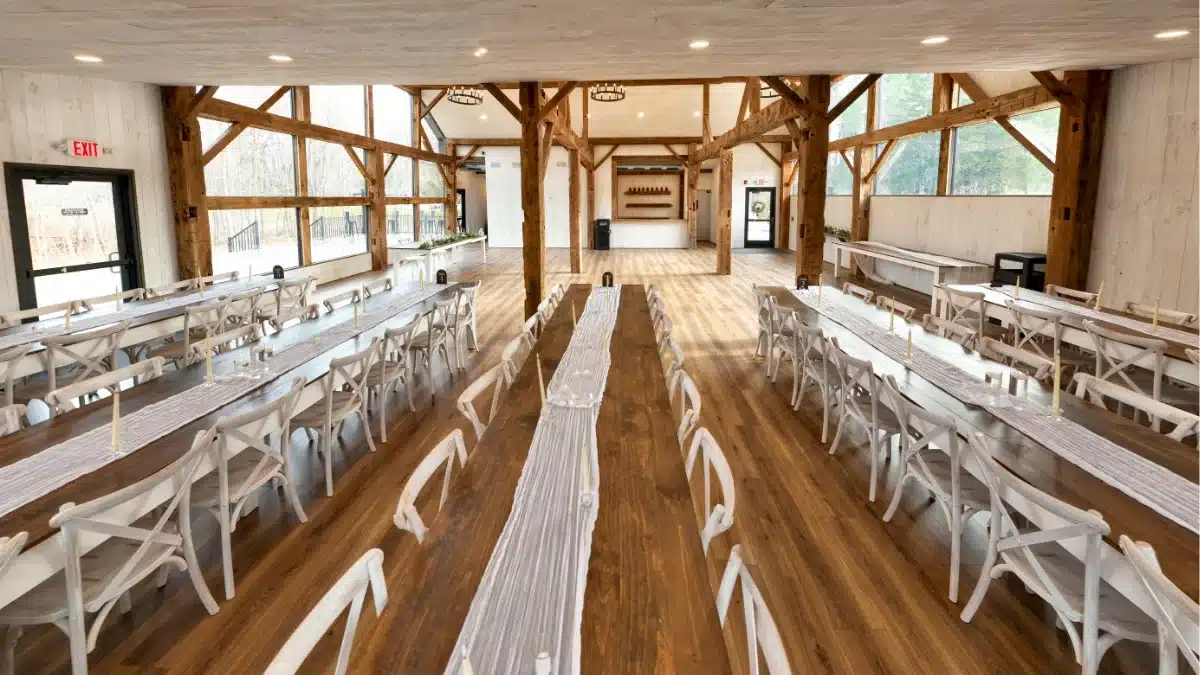 1837 Barn interior at Standing Rock Farms showing historic timber beams and intimate wedding reception setup