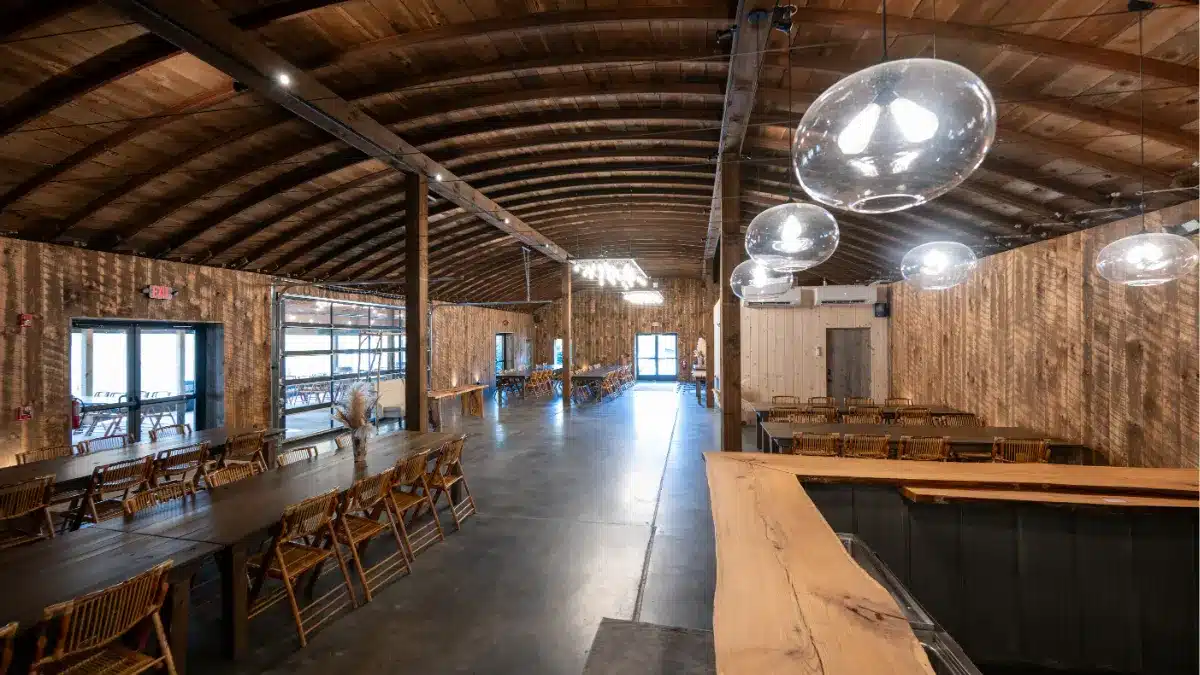 Barrel Room wedding venue at Standing Rock Farms with dramatic truss ceiling and wooded patio views