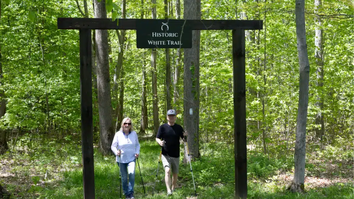 Couple hiking the Historic White Trail at Standing Rock Farms farm stay near Madison Ohio